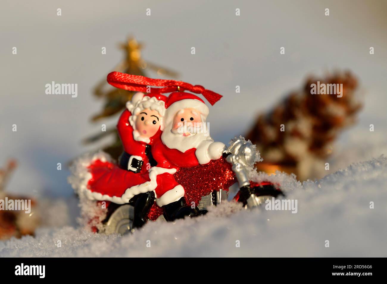 Christmas decorations, Santa and Mrs Claus riding through the snow on a motorbike Stock Photo