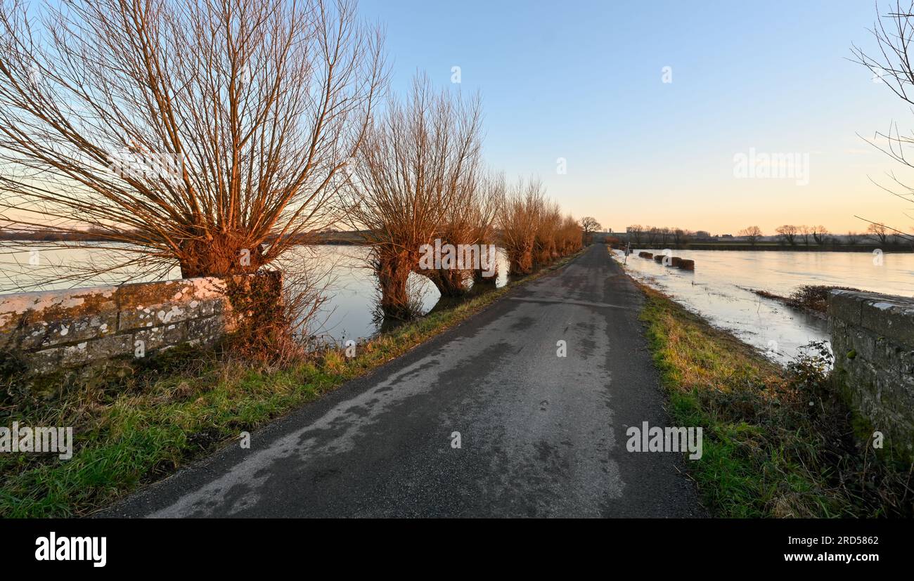 Road through the flooded and frozen Somerset Levels at Hambridge near Langport Stock Photo