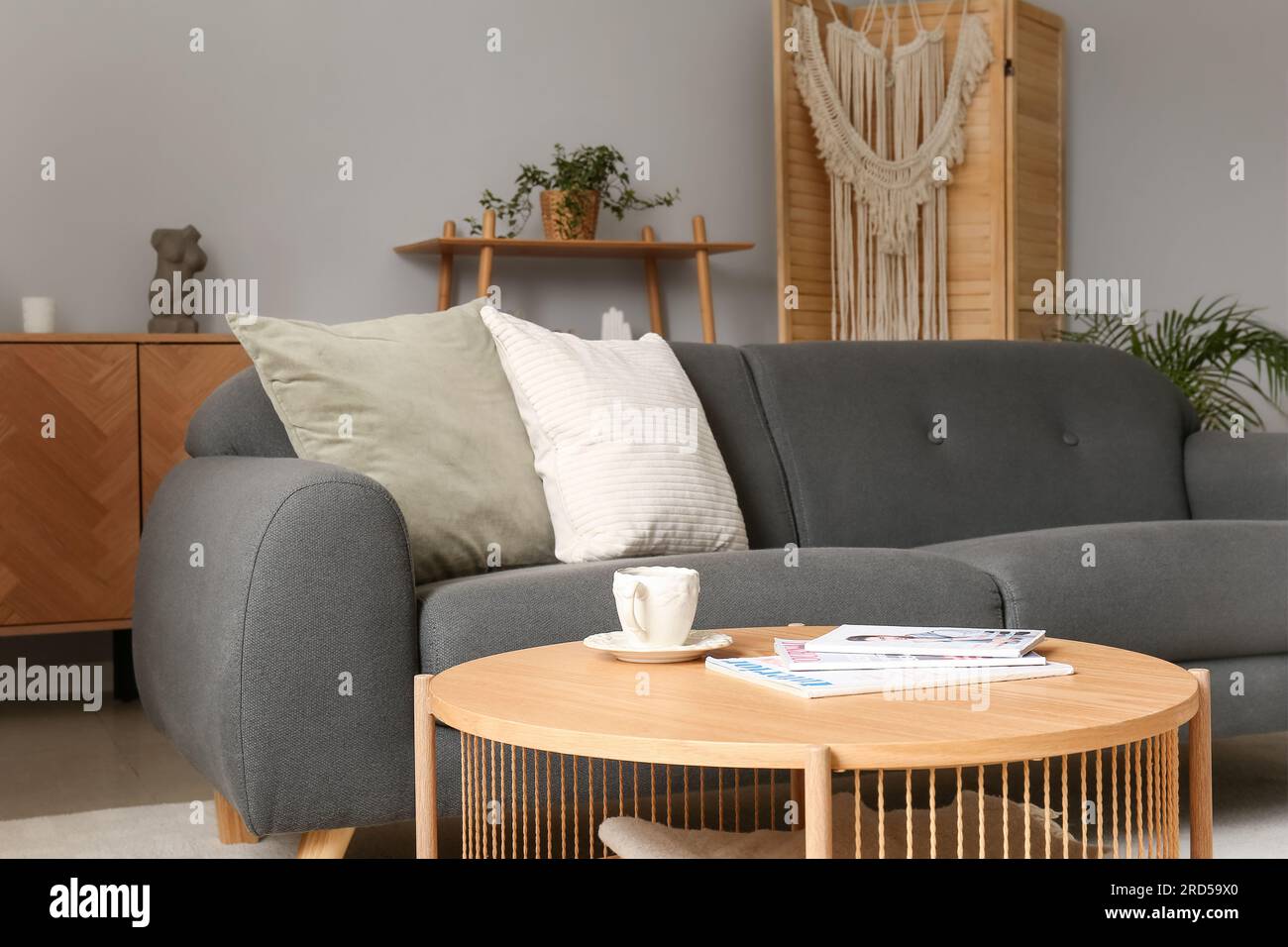 Interior of living room with grey sofa and wooden coffee table Stock ...