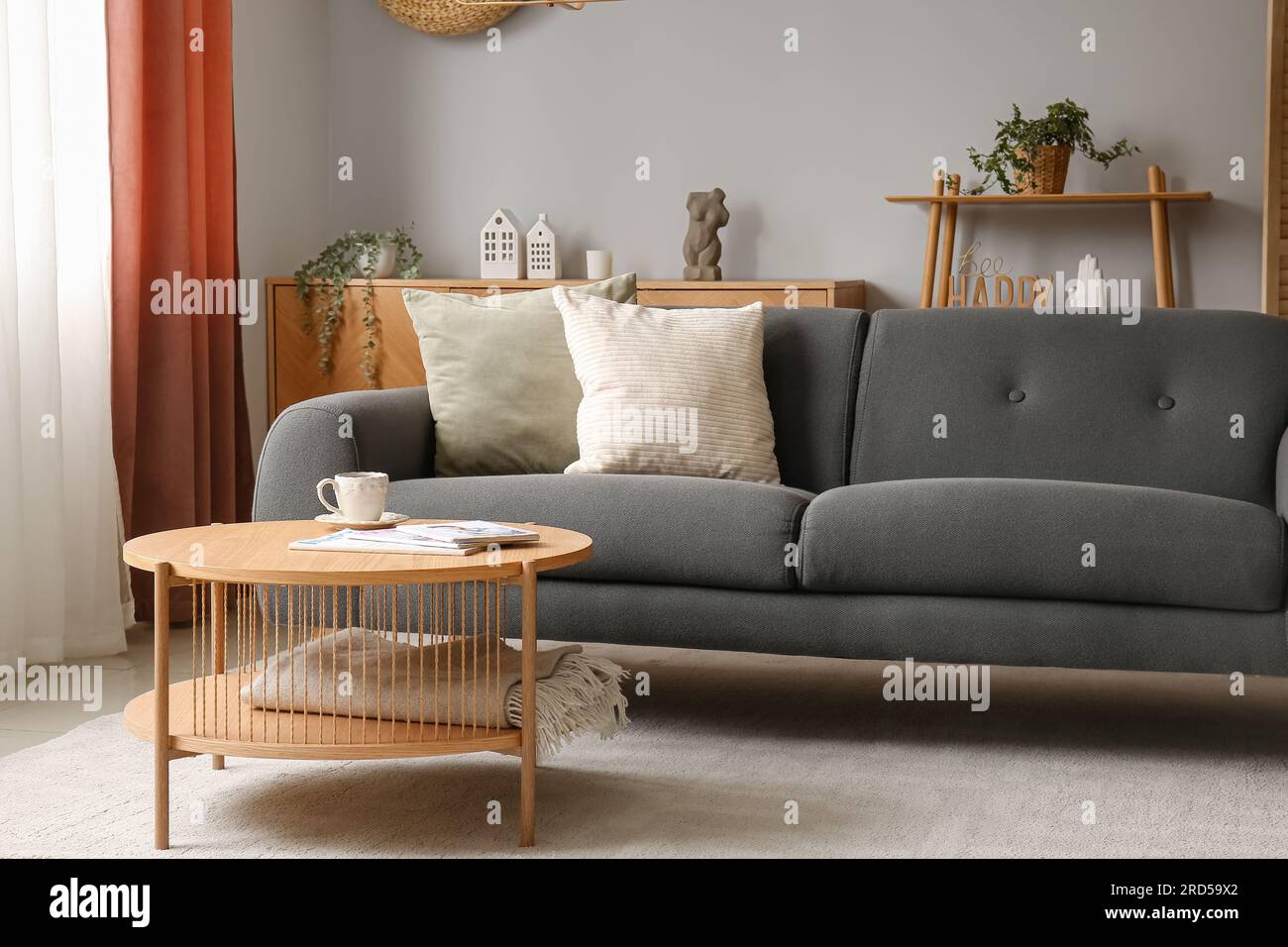 Interior of living room with grey sofa and wooden coffee table Stock ...