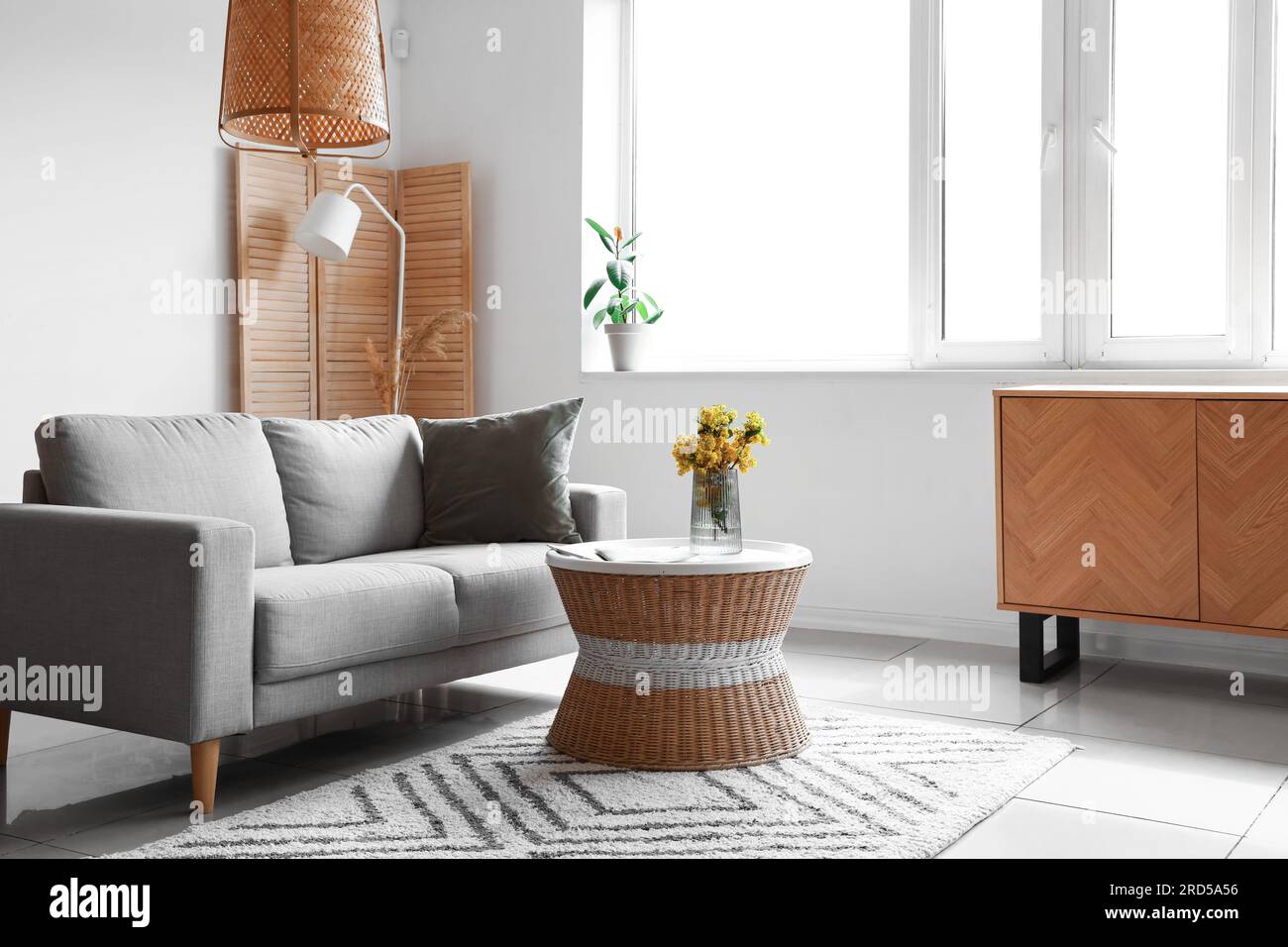 Interior of light living room with grey sofa, table and window Stock ...