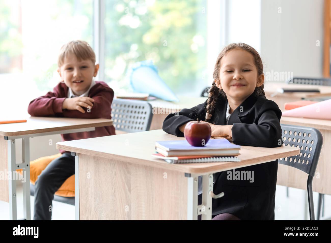 Happy classmates sitting at desks in classroom Stock Photo Alamy Happy classmates sitting at desks in classroom Stock Photo Alamy
