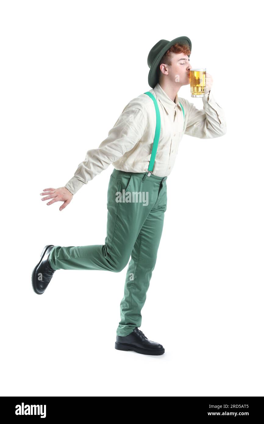 Young man in traditional German clothes with beer on white background