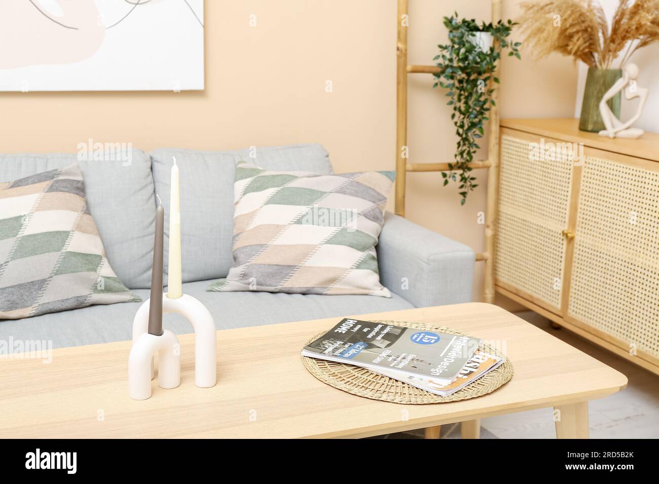 Modern living room interior with table, grey sofa and cabinet Stock