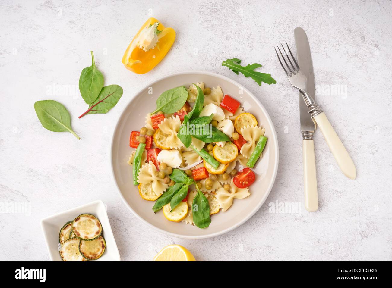 Plate of tasty pasta salad with peas and basil on white background Stock Photo Alamy
