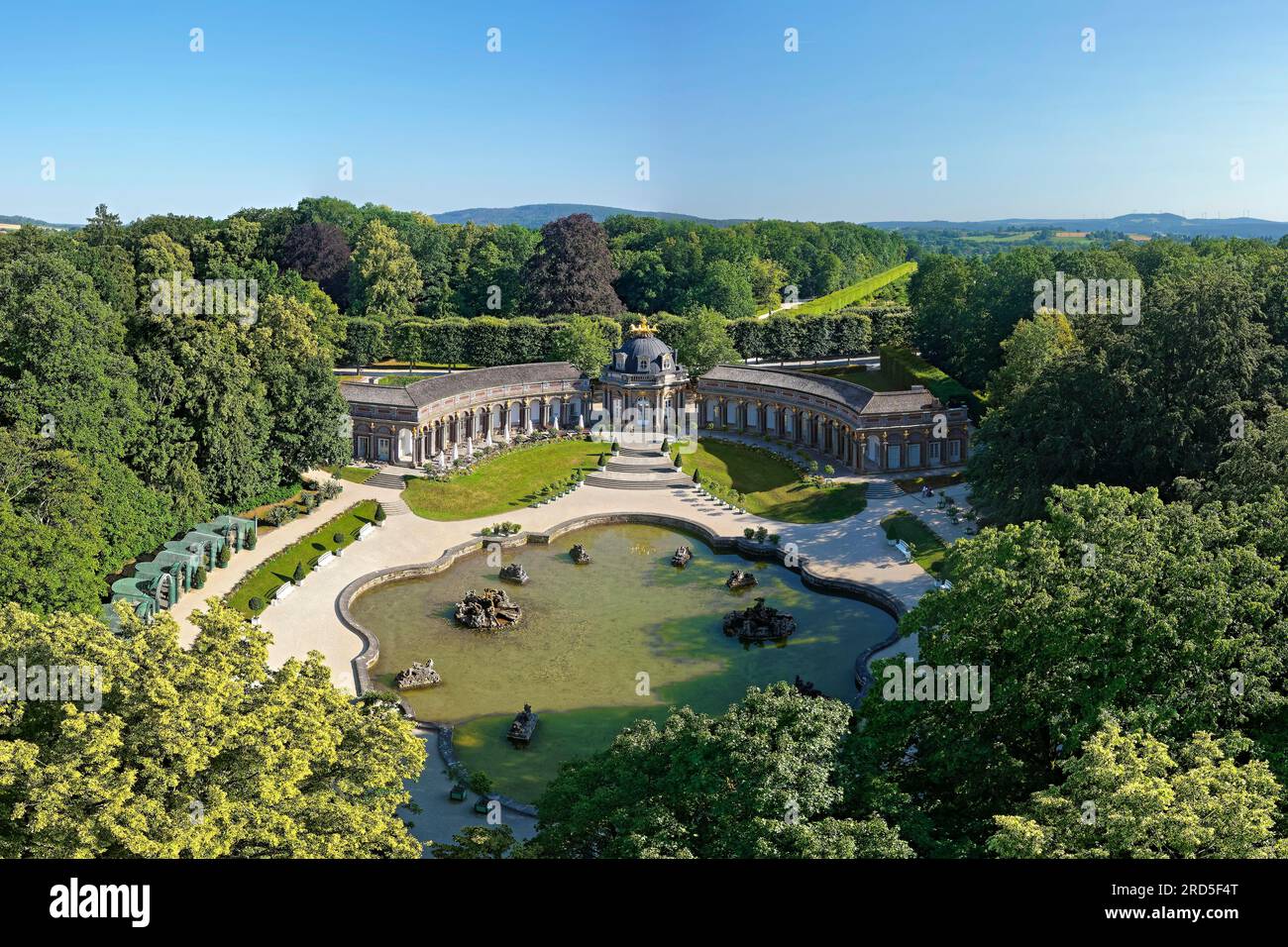 New Palace, orangery with central sun temple, circular buildings on both sides with arcade tract and golden quadriga on the roof, water basin in Stock Photo