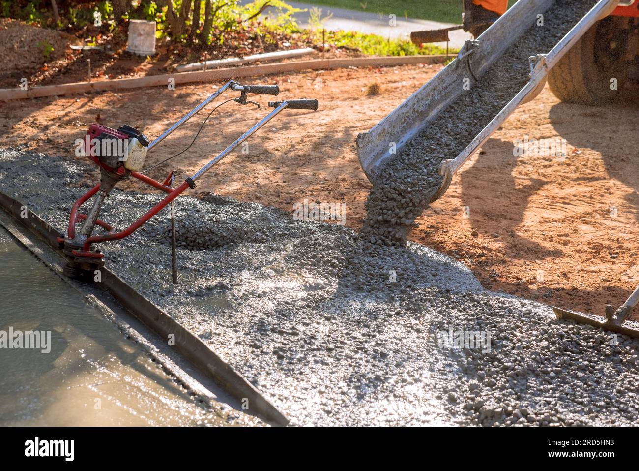 In front of home mixer truck pours wet cement ready mixed concrete for