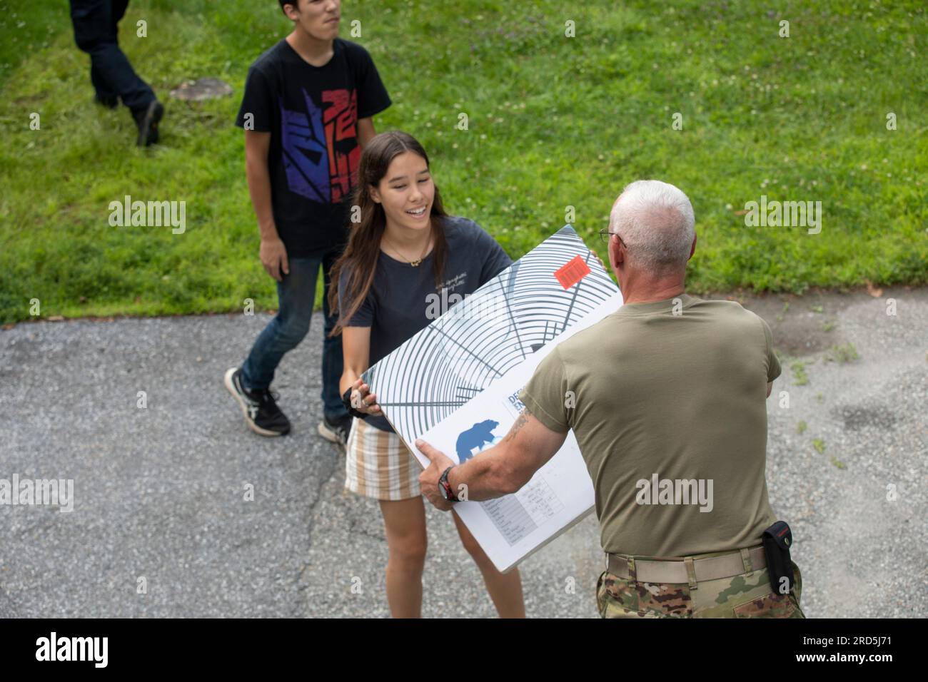 Hardwick, United States Of America. 17th July, 2023. Hardwick, United States of America. 17 July, 2023. A U.S. Army soldier with the Vermont Army National Guard, right, hands a donated electric fan to a young resident in the aftermath of floods, July 17, 2023 in Hardwick, Vermont. Soldiers helped organize and distribute donated items to towns affected by flooding across Vermont. Credit: Sgt. Denis Nunez/U.S. Army Photo/Alamy Live News Stock Photo