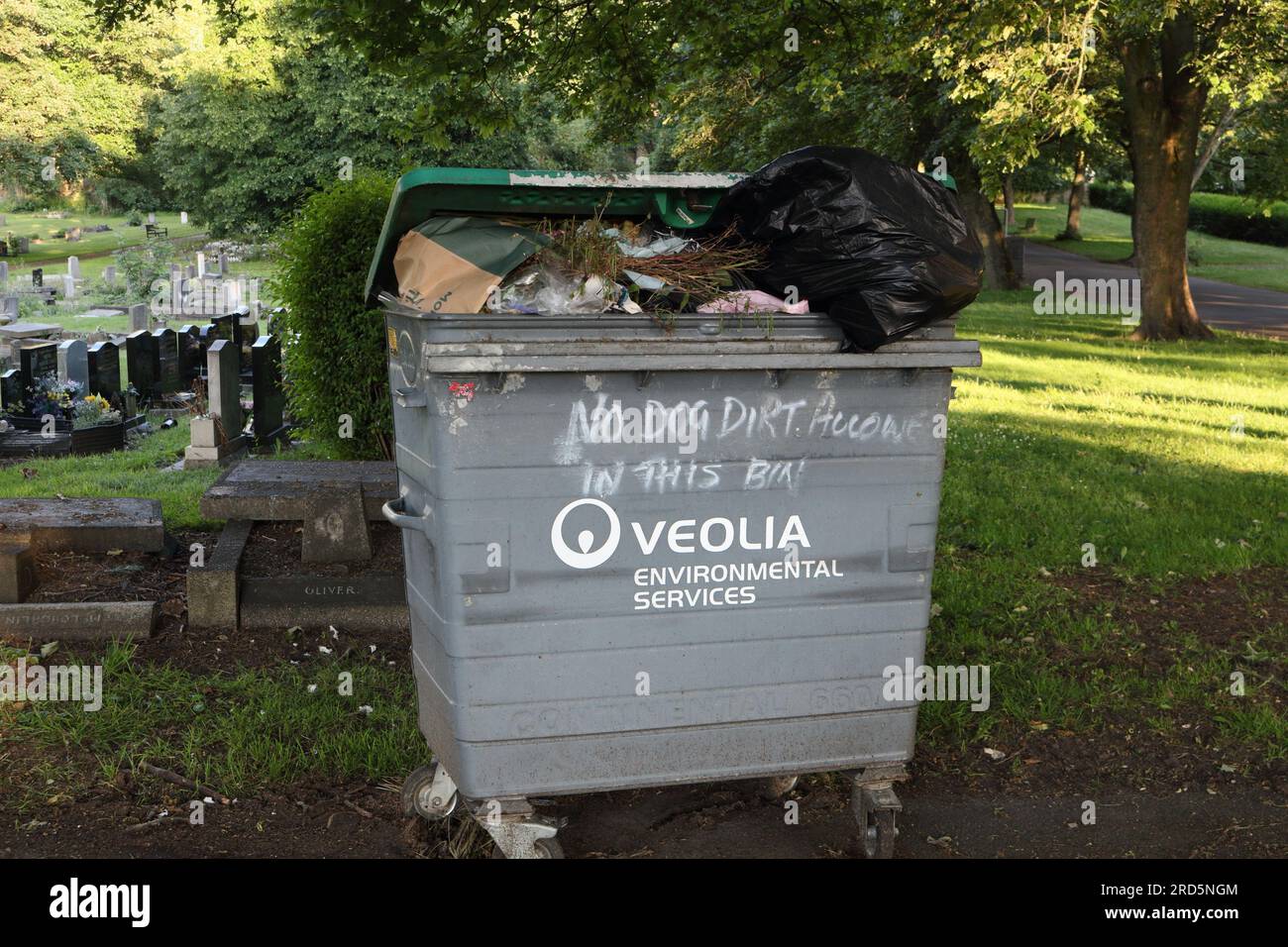Veolia Large rubbish container bin in cemetery, No dog dirt allowed in this bin Stock Photo