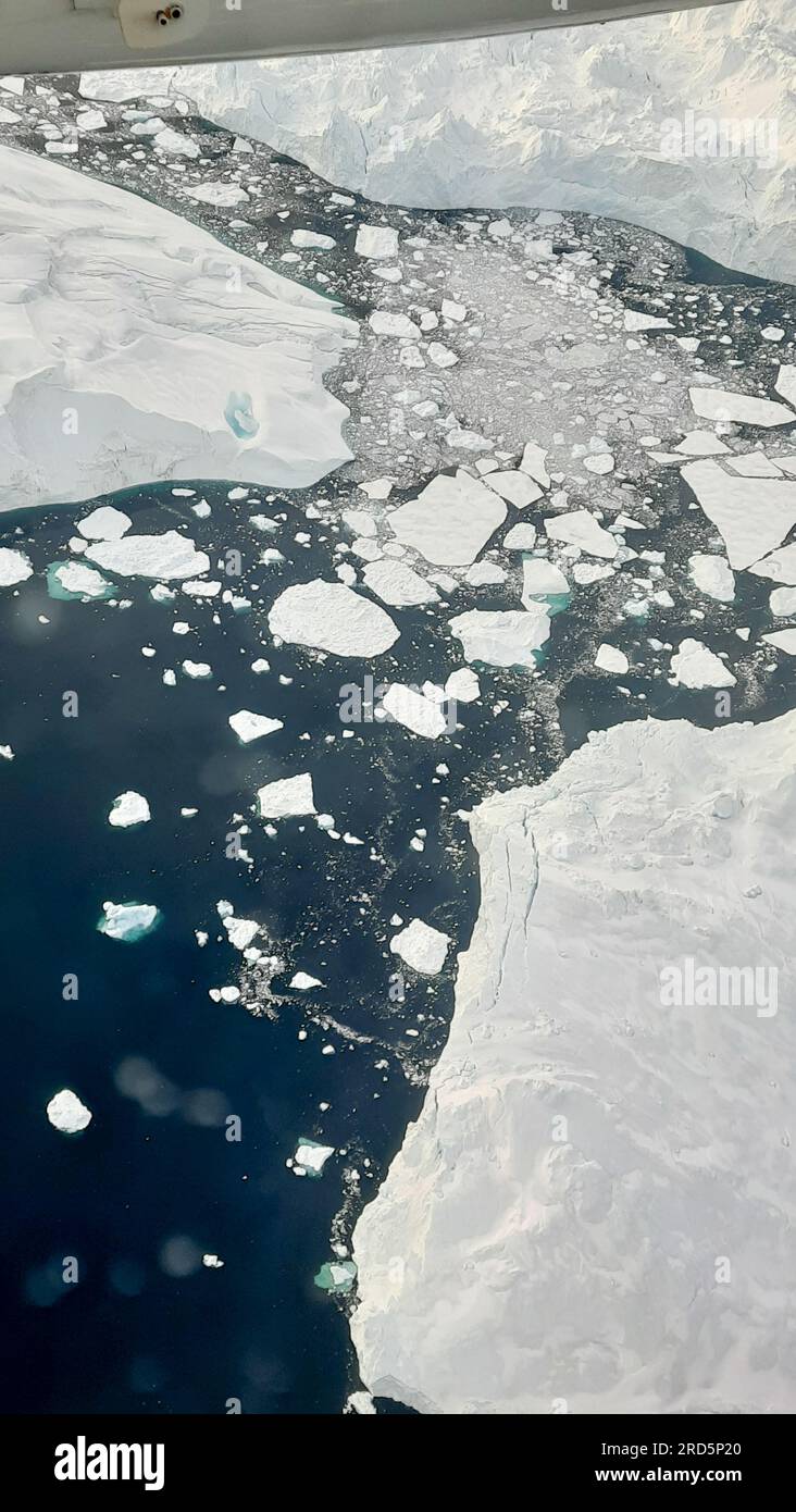 Aerial View To Ilulissat Icefjord In Greenland With Big Scenic Iceberg aerial-view-to-ilulissat-icefjord-in-greenland-with-big-scenic-iceberg