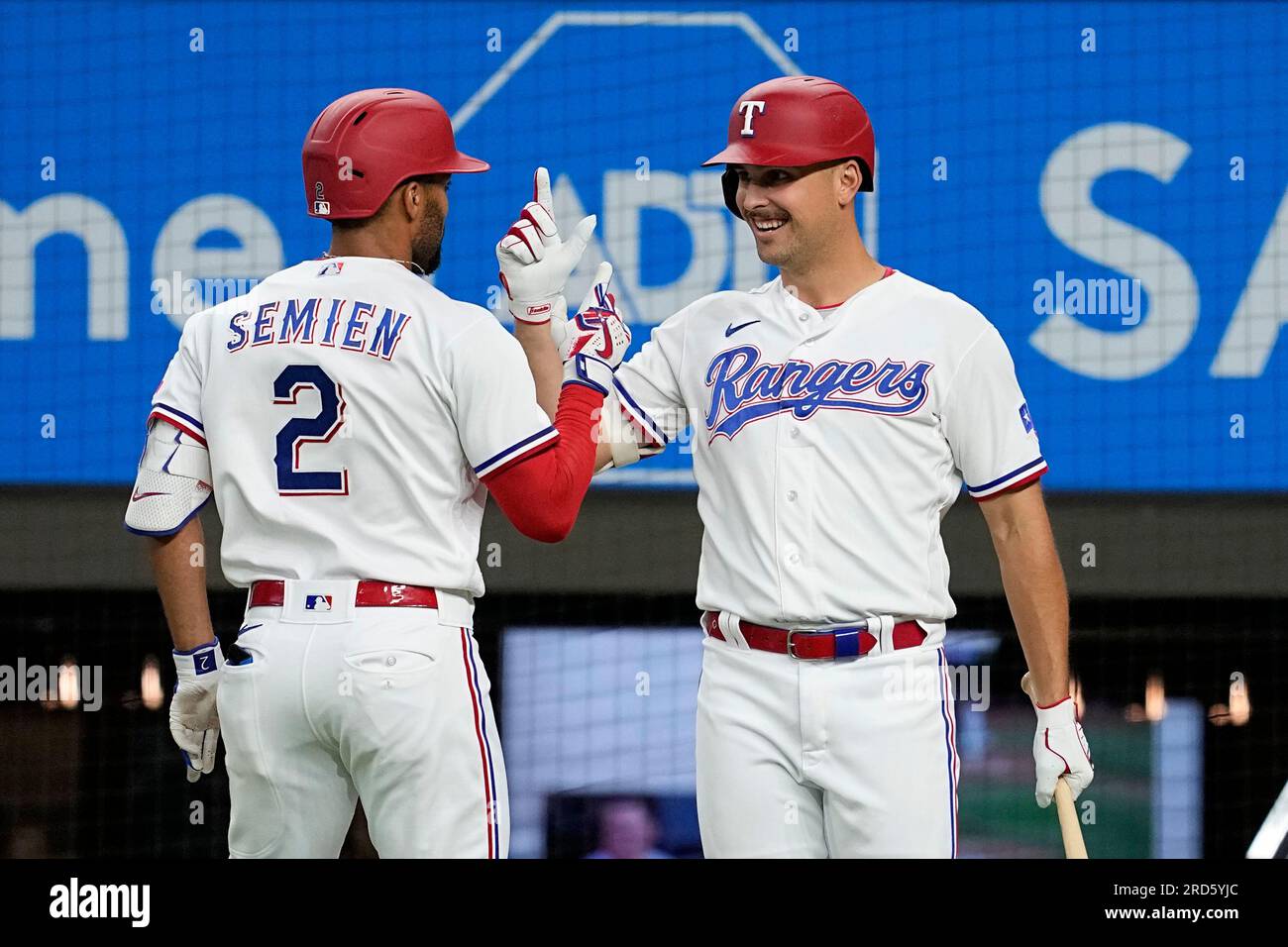 Texas Rangers' Marcus Semien (2) and Nathaniel Lowe, right, celebrate after Semien hit a solo home run against the Tampa Bay Rays during the third inning of a baseball game Tuesday, July