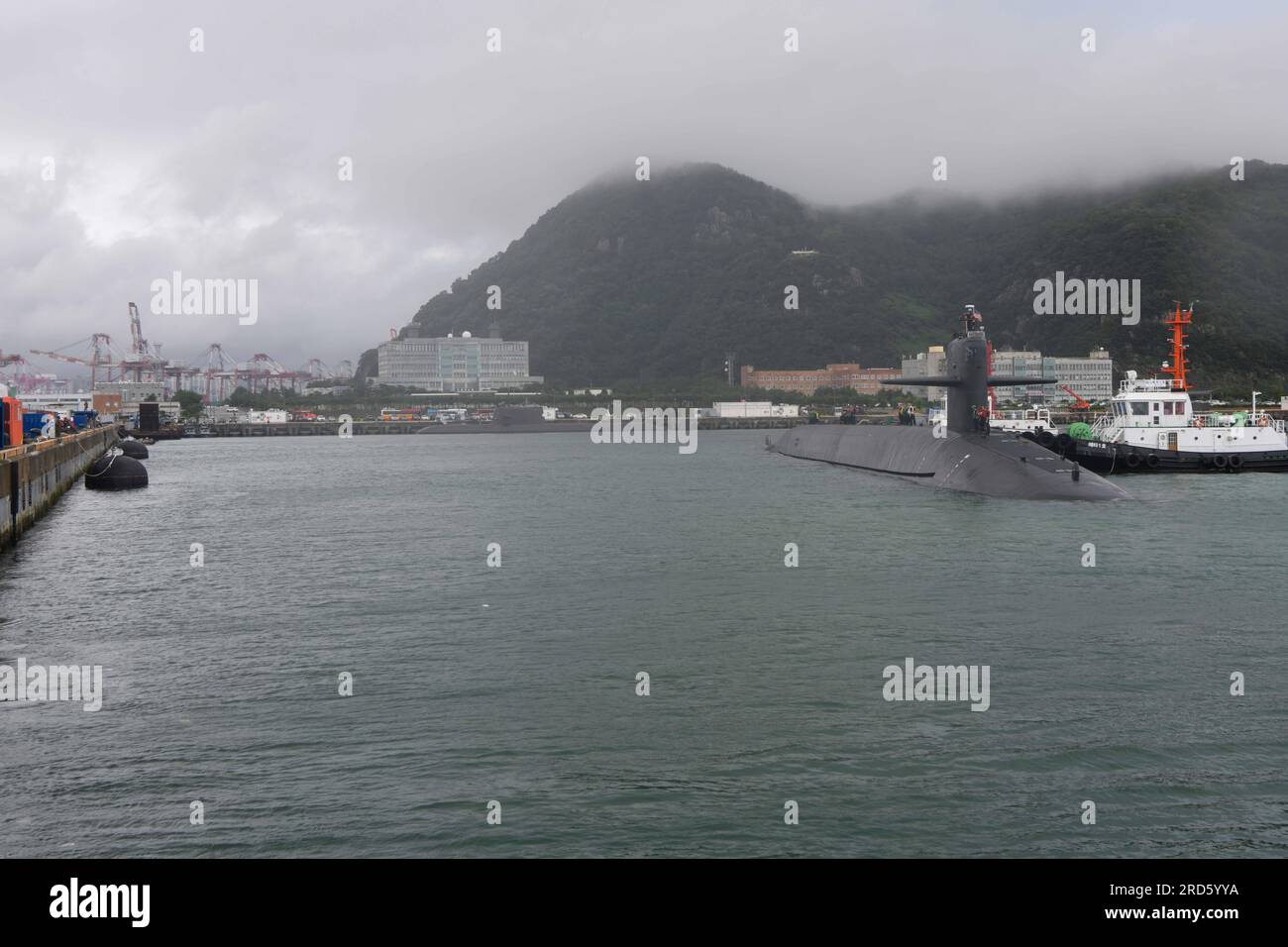230718-N-ZU710-0125 BUSAN, Republic of Korea (July 18, 2023) - The Ohio-class ballistic-missile submarine USS Kentucky (SSBN 737) pulls into port in Busan. Homeported in Naval Base Kitsap, Bangor, Washington, Kentucky is a launch platform for submarine-launched ballistic missiles, providing the United States with its most survivable leg of the nuclear triad. The visit represents the United States’ ironclad commitment to the Republic of Korea (ROK) for its extended deterrence guarantee, and compliments the many exercises, training, operations, and other military cooperation activities conducted Stock Photo