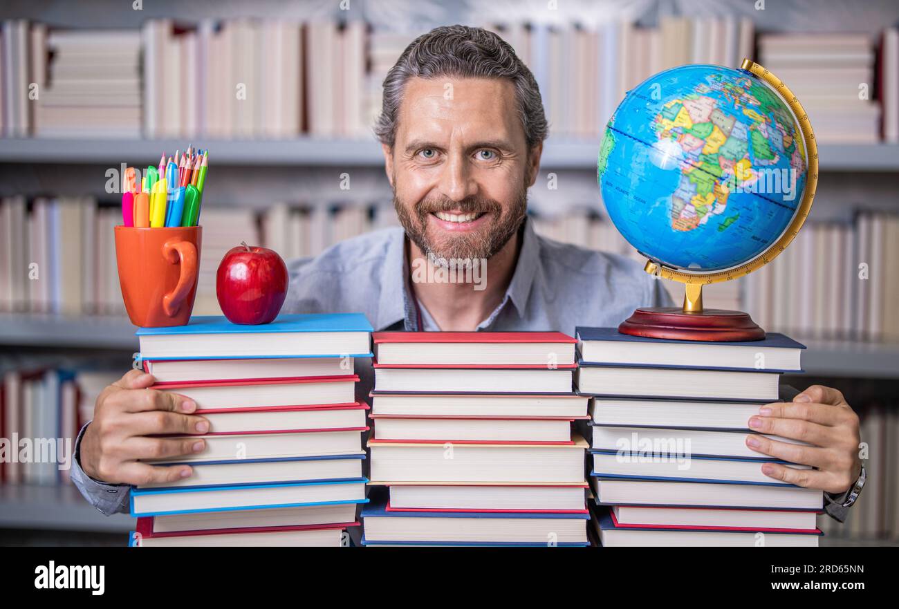 university teacher professor in school classroom library preparing for ...