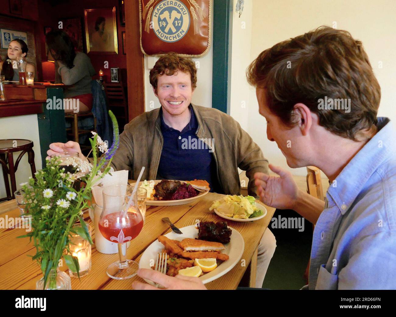 San Francisco, USA. 29th June, 2023. Guests sit in front of full plates at the German restaurant 'Suppenküche'. San Francisco is known for its many kitchens and restaurants. Of all places, two Bavarians open a pub there - that was 30 years ago. The 'Suppenküche' is still a success story today. (to dpa: '30 years of 'Suppenküche' - with sausage and beer in San Francisco to success') Credit: Barbara Munker/dpa/Alamy Live News Stock Photo