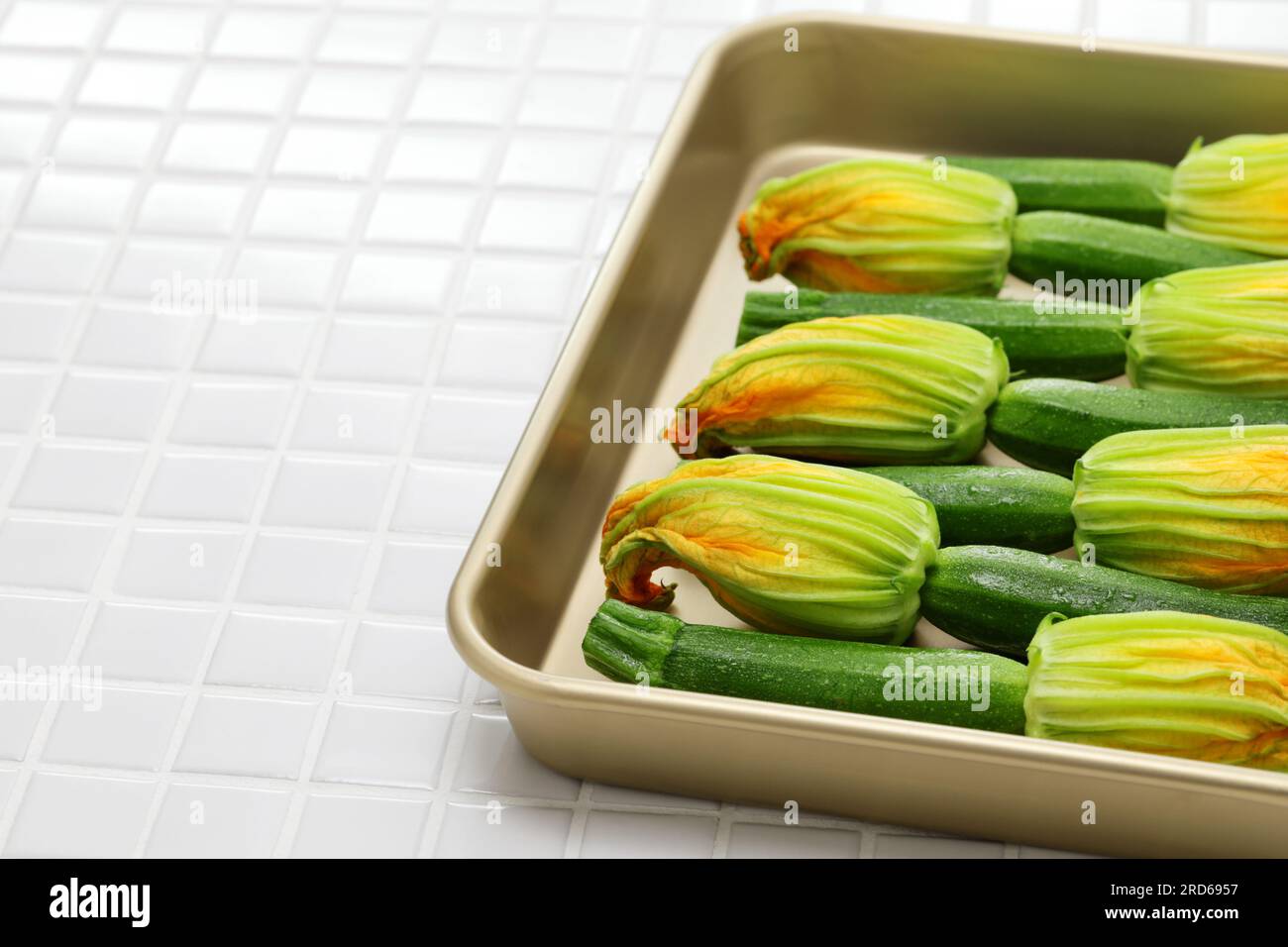 zucchini flowers in a tray, copy space Stock Photo