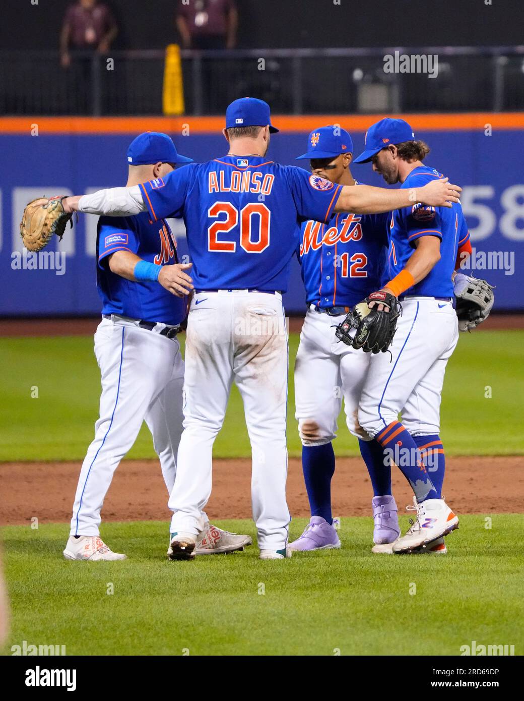 New York Mets shortstop Luis Guillorme (13) and Pete Alonso, right, tear  the jersey off teammat …