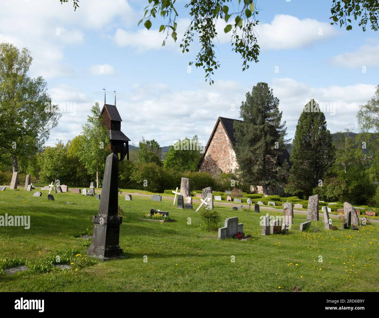 RAGUNDA, SWEDEN ON JUNE 07, 2023. View of the cemetery, headstones, belfry, and the old church. Morning. Editorial use. Stock Photo