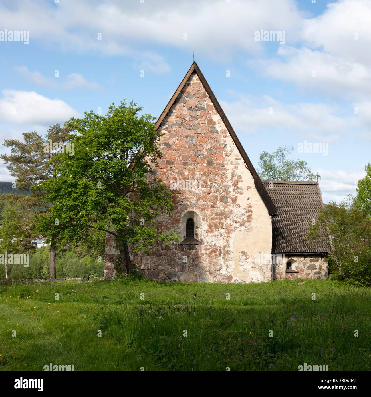 RAGUNDA, SWEDEN ON JUNE 07, 2023. View of an old stone church. Built-in the late 15th, the wall and surrounding. Editorial use. Stock Photo
