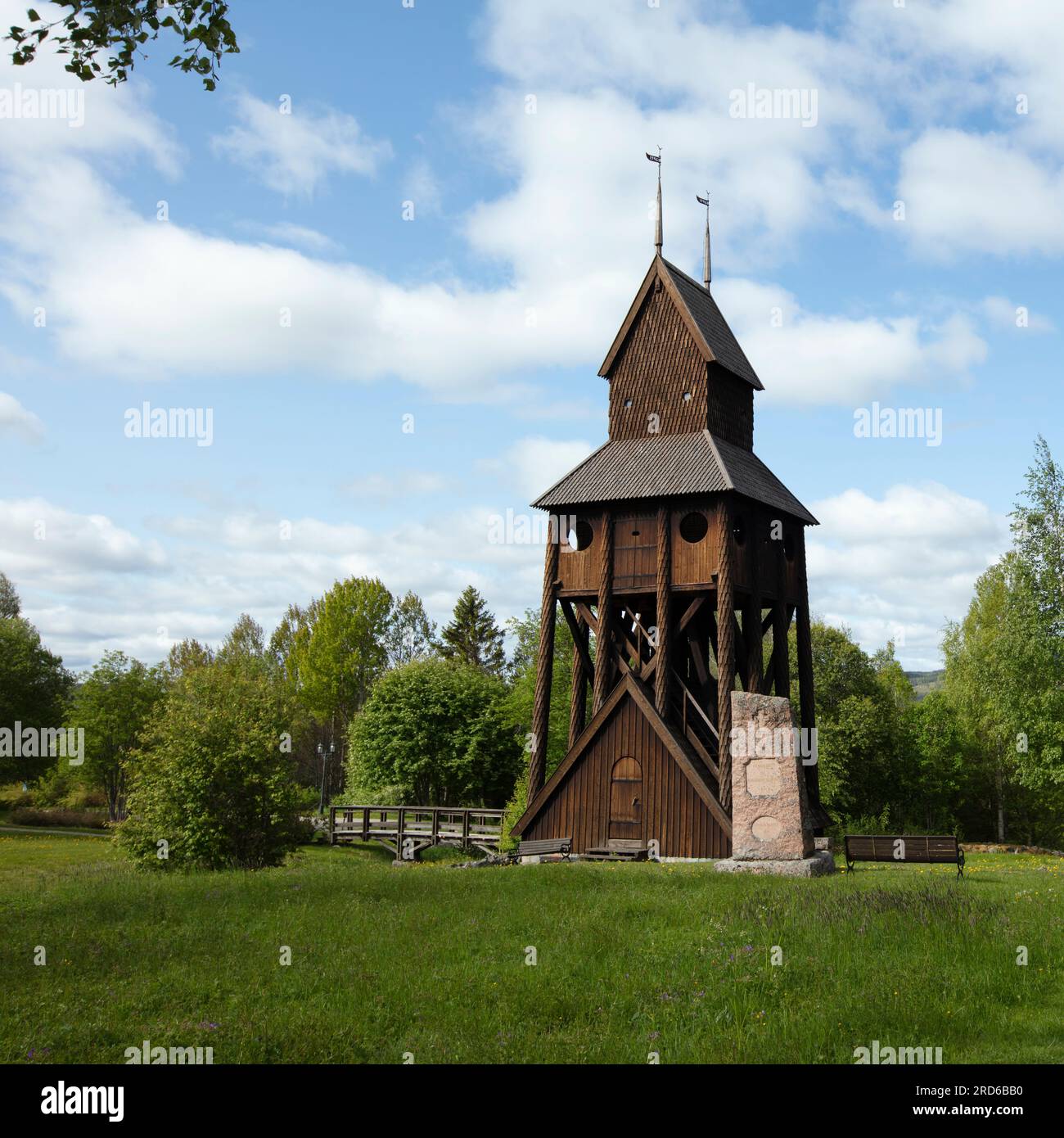 RAGUNDA, SWEDEN ON JUNE 07, 2023. View of a traditional wooden belfry. Trees and bridge. Editorial use. Stock Photo