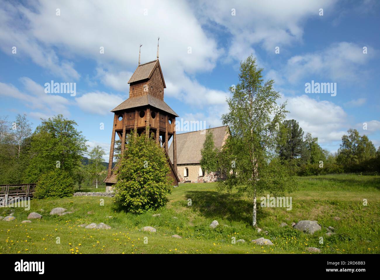 RAGUNDA, SWEDEN ON JUNE 07, 2023. View of a park, a traditional wooden belfry, and an old church. Editorial use. Stock Photo