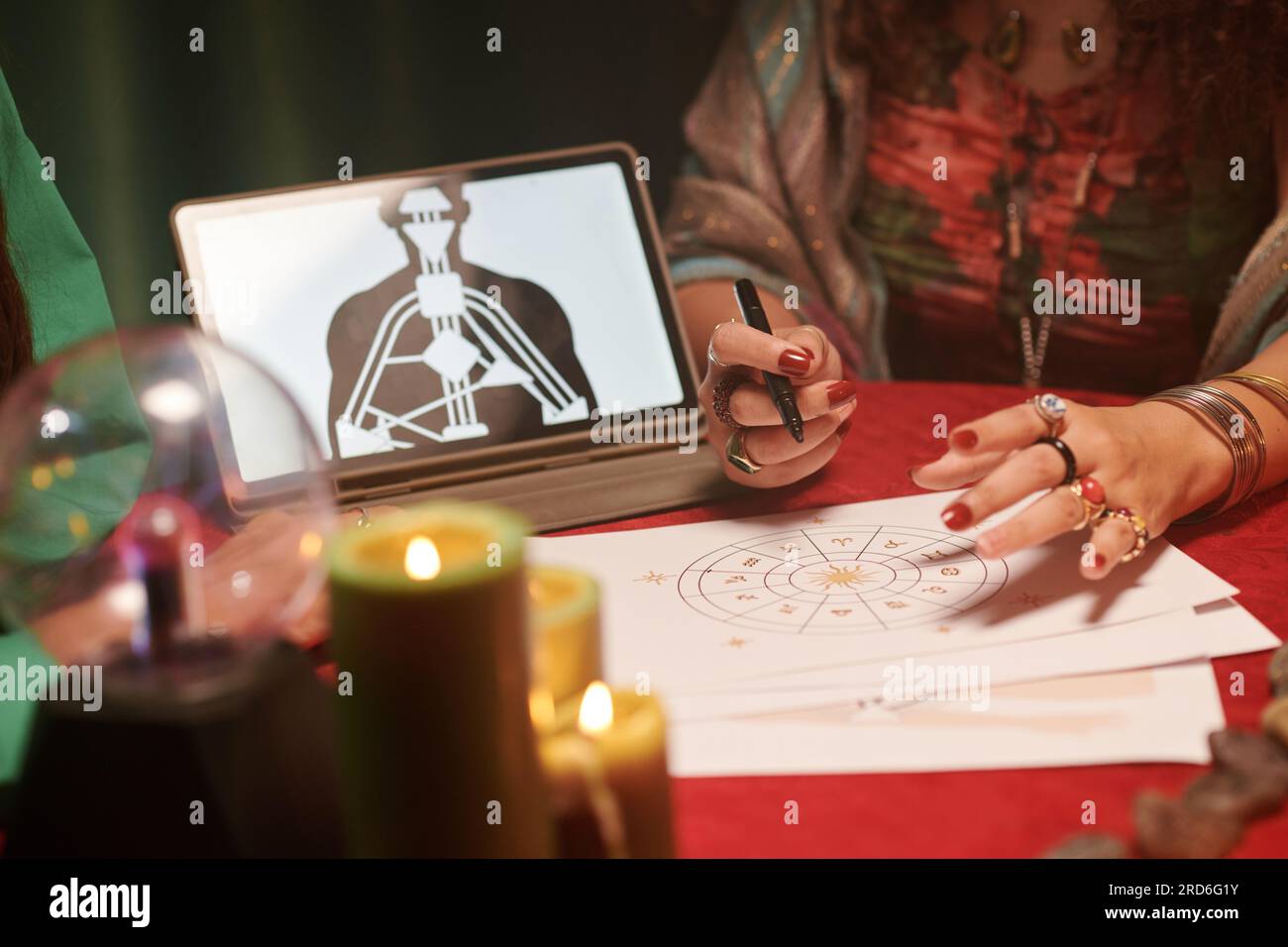 Fortune teller reading and interpreting astrology birth chart Stock