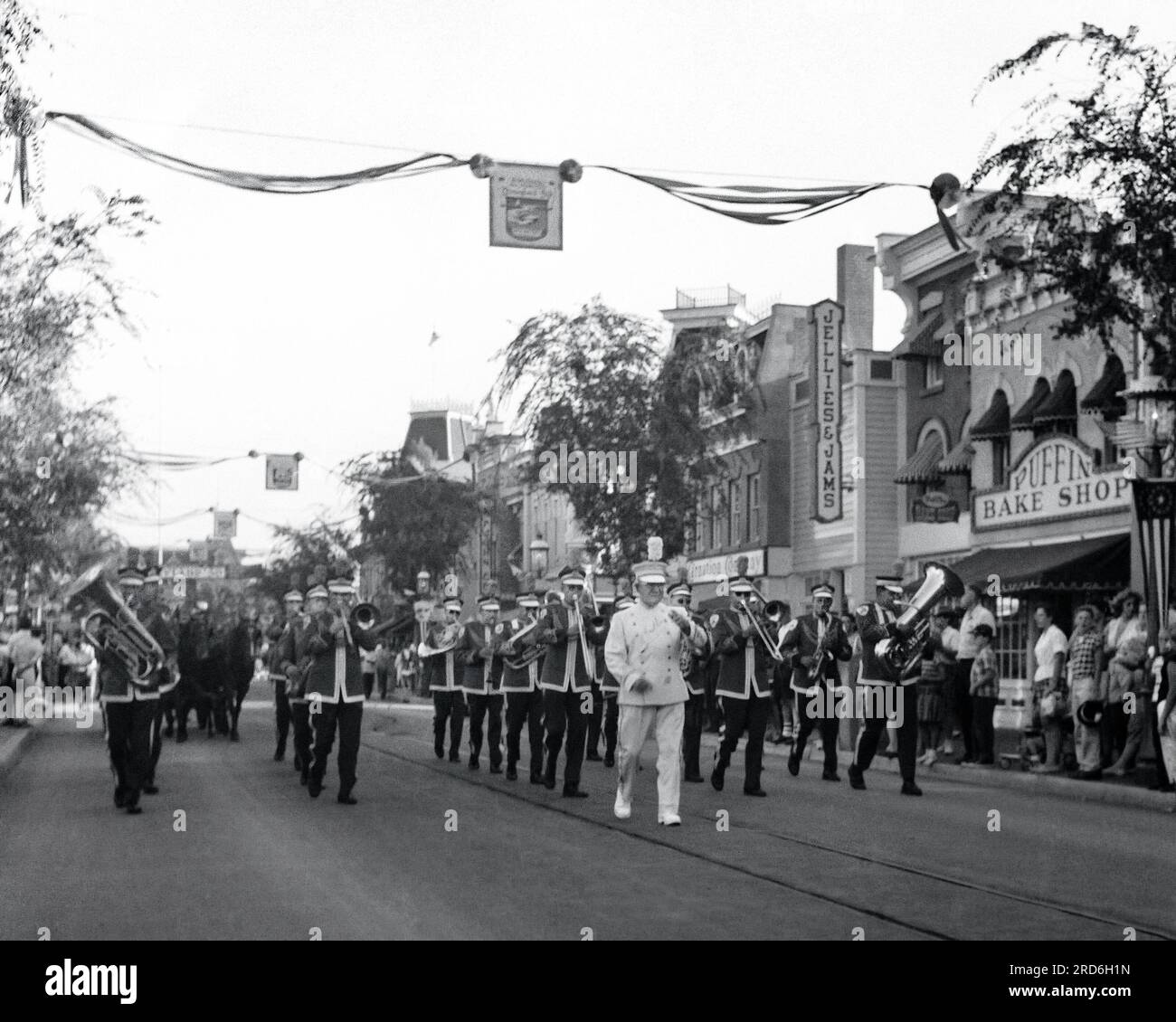 The Disneyland Band marches past the Puffin Bake Shop, Sunny View Farms
