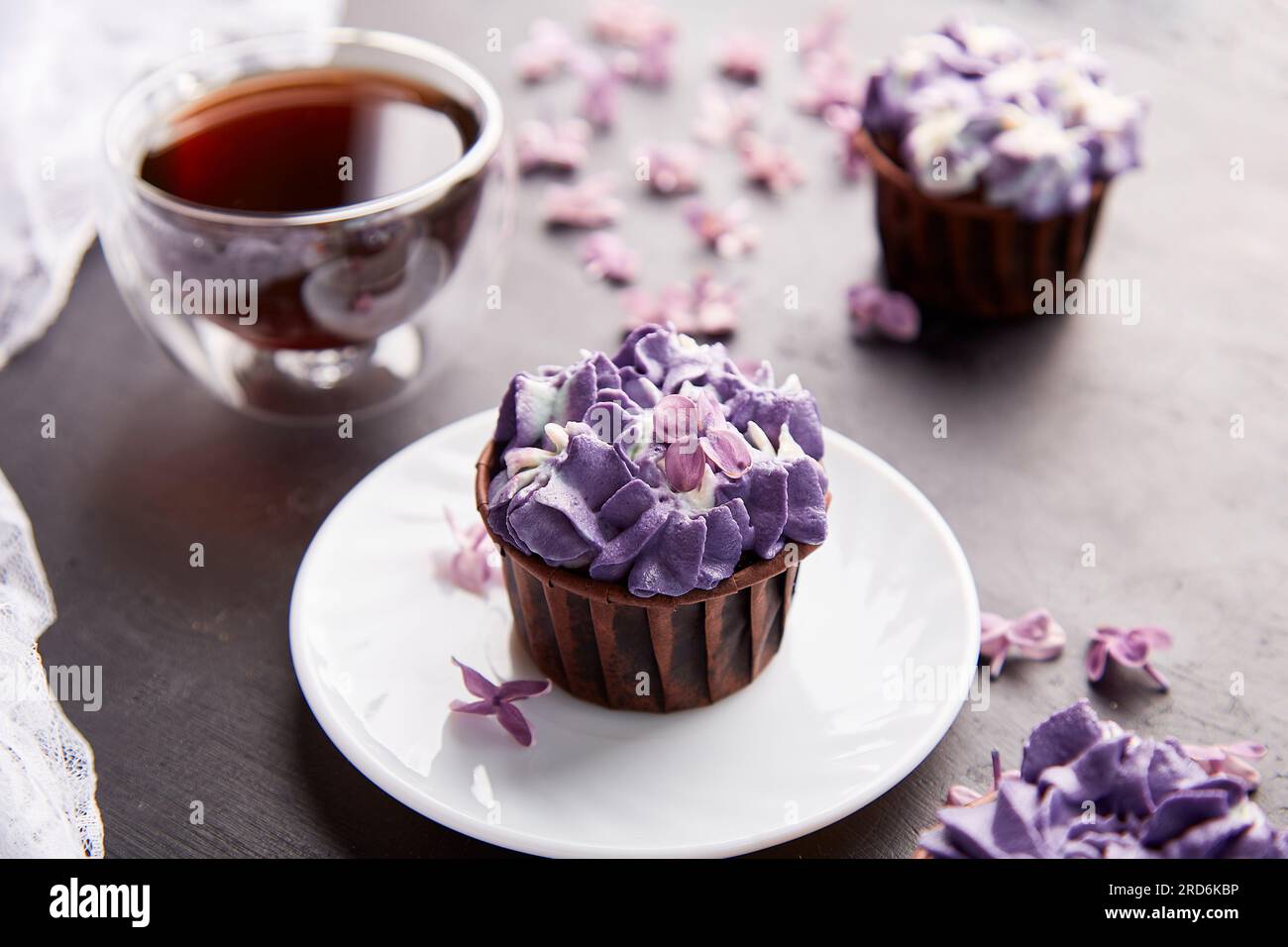 Aesthetics purple trendy floral cupcakes with cup of coffee. Violet sweet  no sugar dessert among lilac flowers Stock Photo - Alamy, image size:1300x956