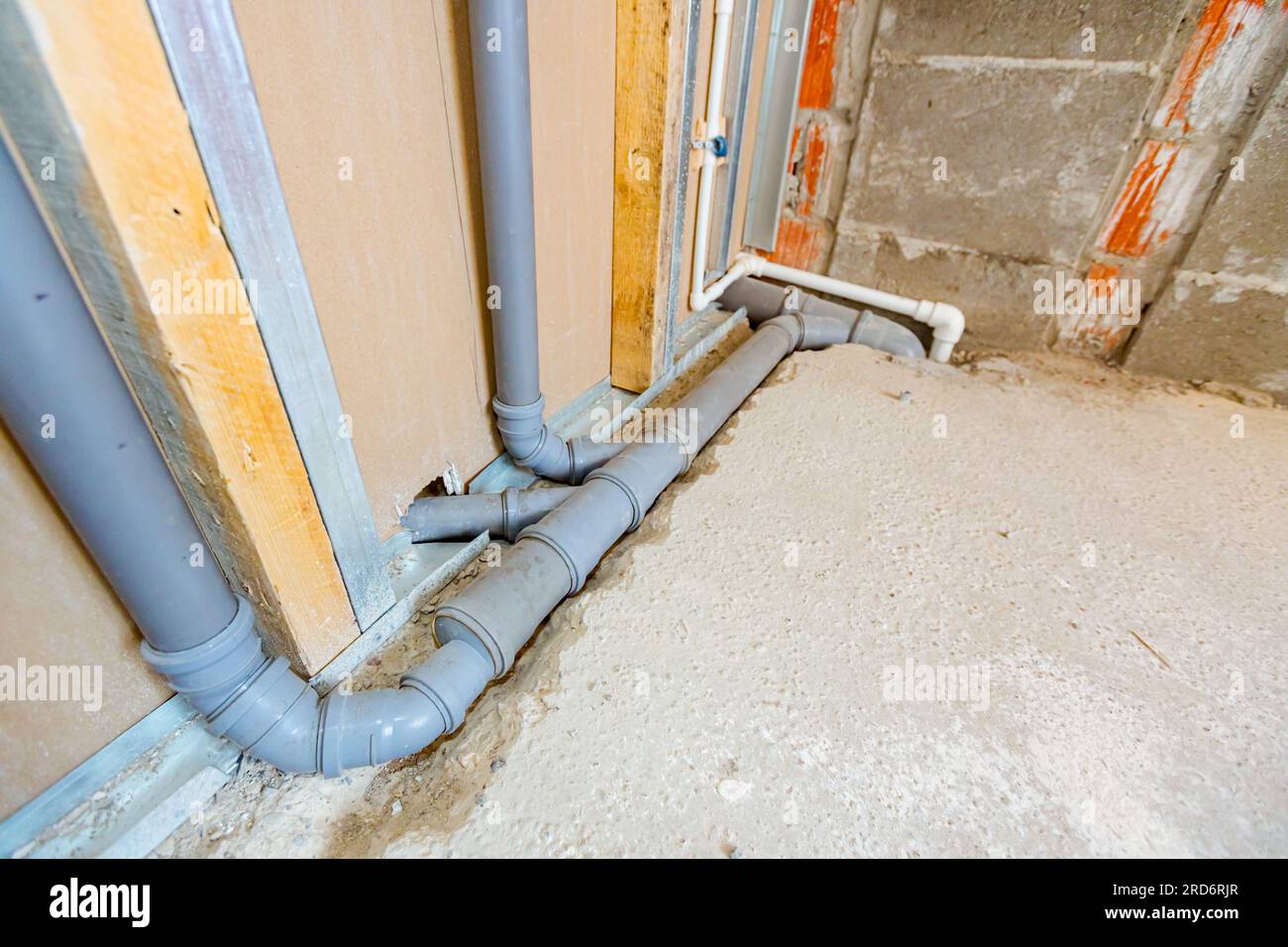 New water installation, exposed mounted grey PVC sewerage pipes mounted