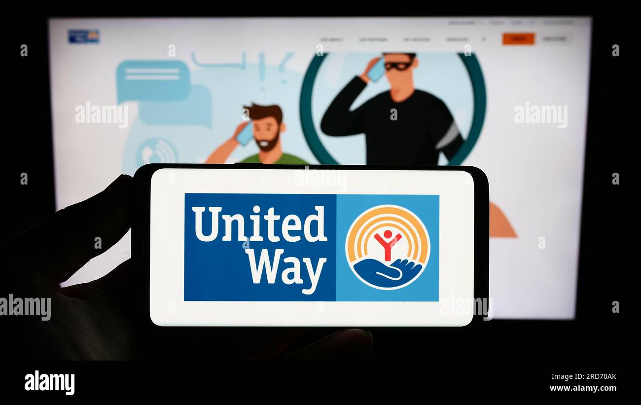 Person holding smartphone with logo of fundraising network United Way
