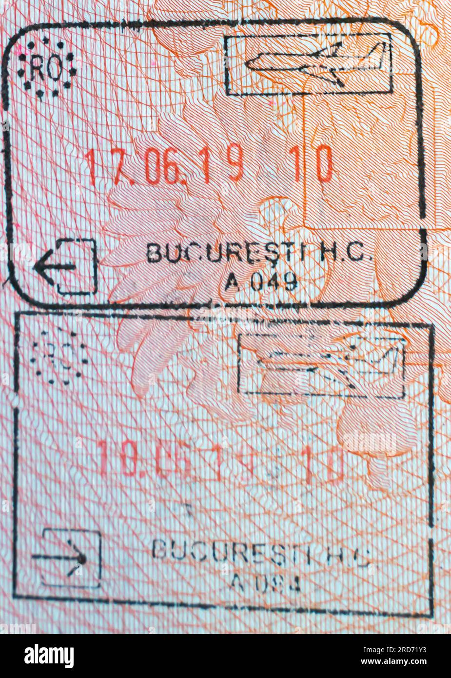 Romanian border crossing stamps with the name of Bucharest border points in an open Russian passport. Romania exit passport stamp. Stock Photo