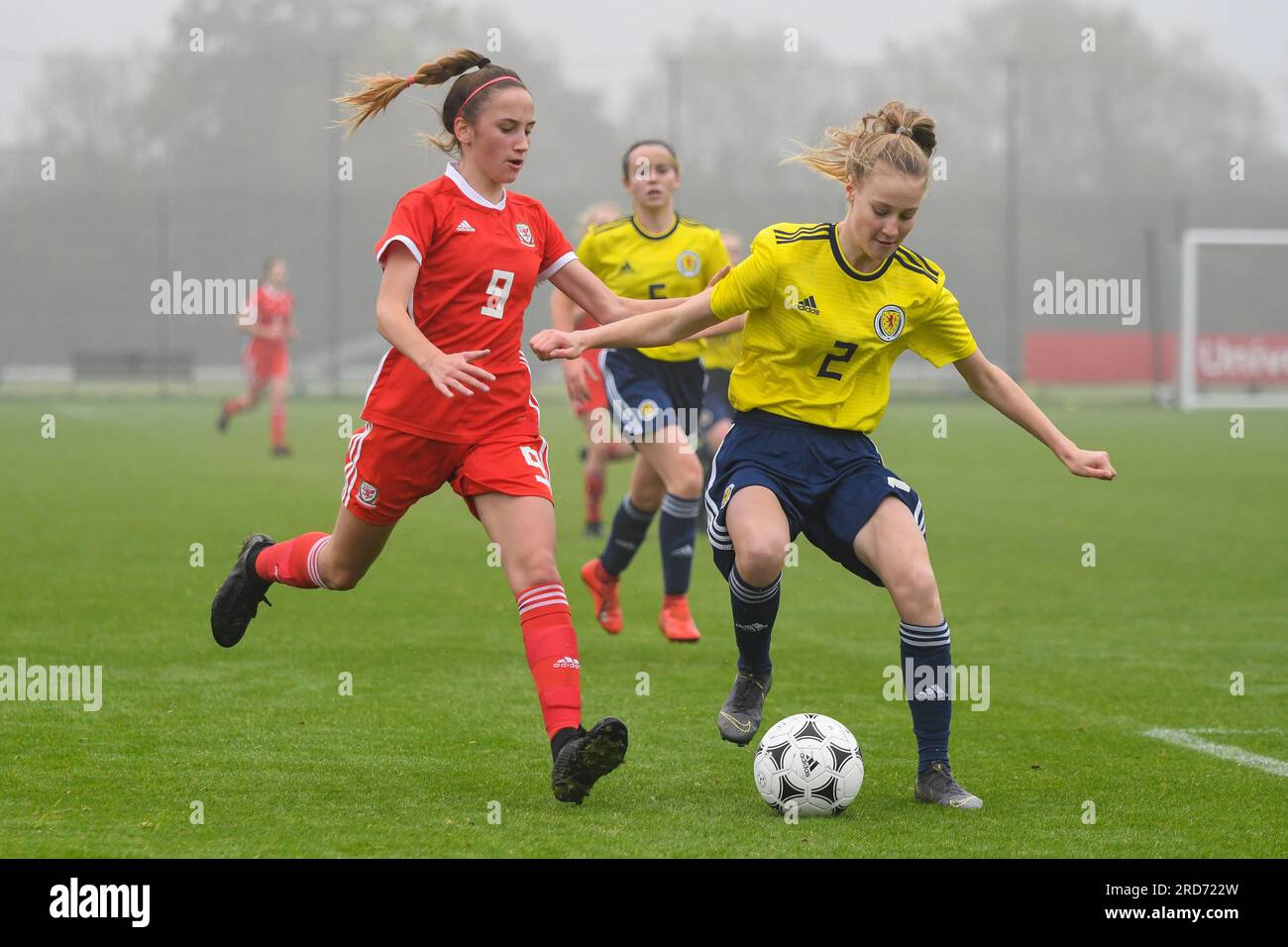 Newport, Wales. 23 October 2019. Georgia Gray of Scotland shields the ball from Olivia Francis of Wales during the Under 15 Girls Friendly International match between Wales and Scotland at Dragon Park in Newport, Wales, UK on 23 October 2019. Credit: Duncan Thomas/Majestic Media. Stock Photo