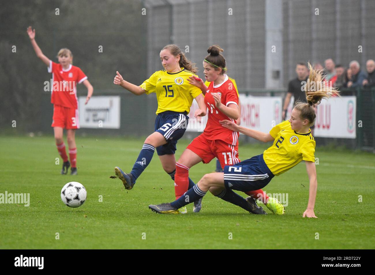 Newport, Wales. 23 October 2019. Niamh Duggan of Wales is tackled by Georgia Gray of Scotland and Georgie Robb of Scotland during the Under 15 Girls Friendly International match between Wales and Scotland at Dragon Park in Newport, Wales, UK on 23 October 2019. Credit: Duncan Thomas/Majestic Media. Stock Photo