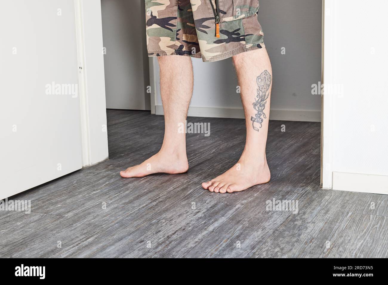 Man standing barefoot on floor Stock Photo - Alamy