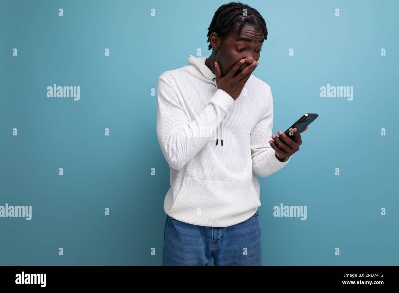 surprised man young african brunette with phone Stock Photo