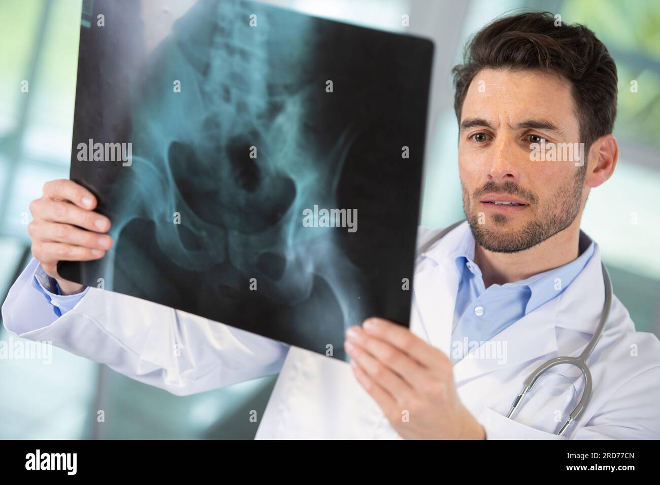 male radiologist looking at an xray Stock Photo Alamy