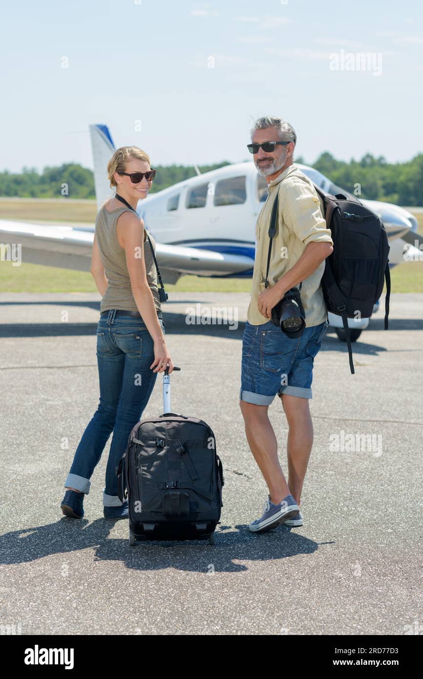 couple boarding airplane in hanger Stock Photo Alamy