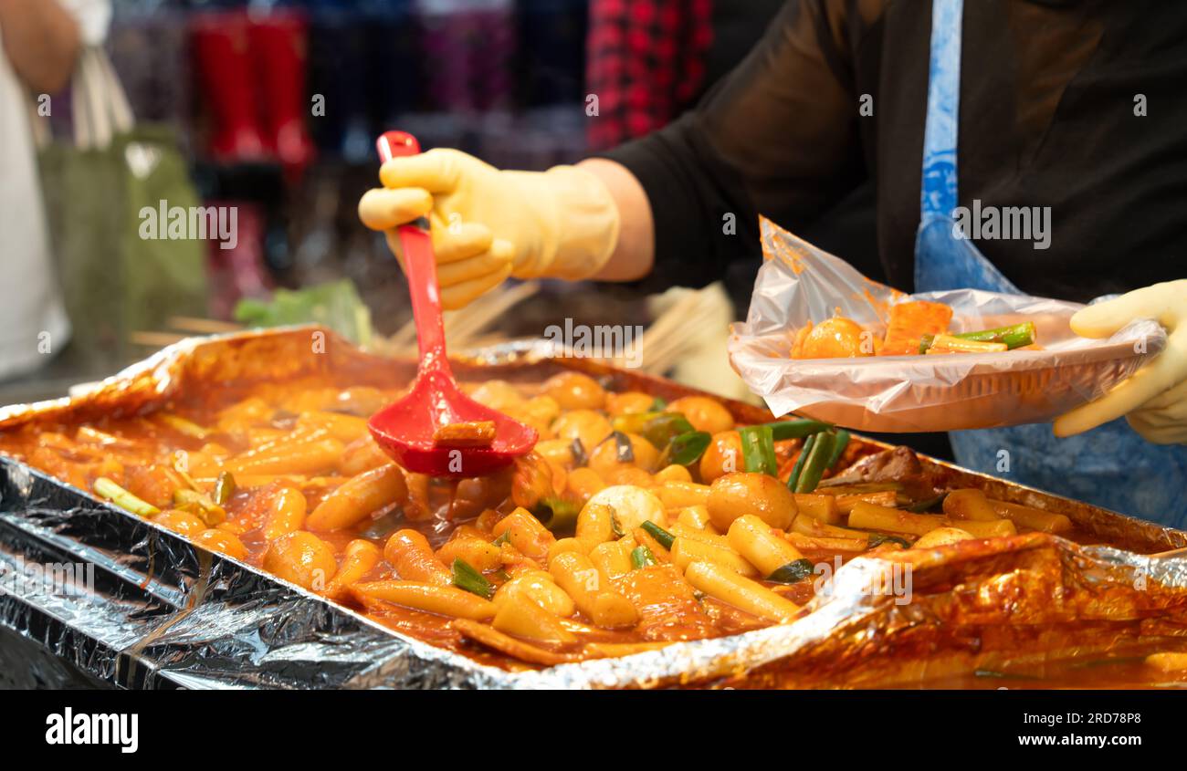 Delicious Korean cuisine Tteokbokki, tasty spicy rice cake with sausages,  eggs in market for street food snacks Stock Photo - Alamy