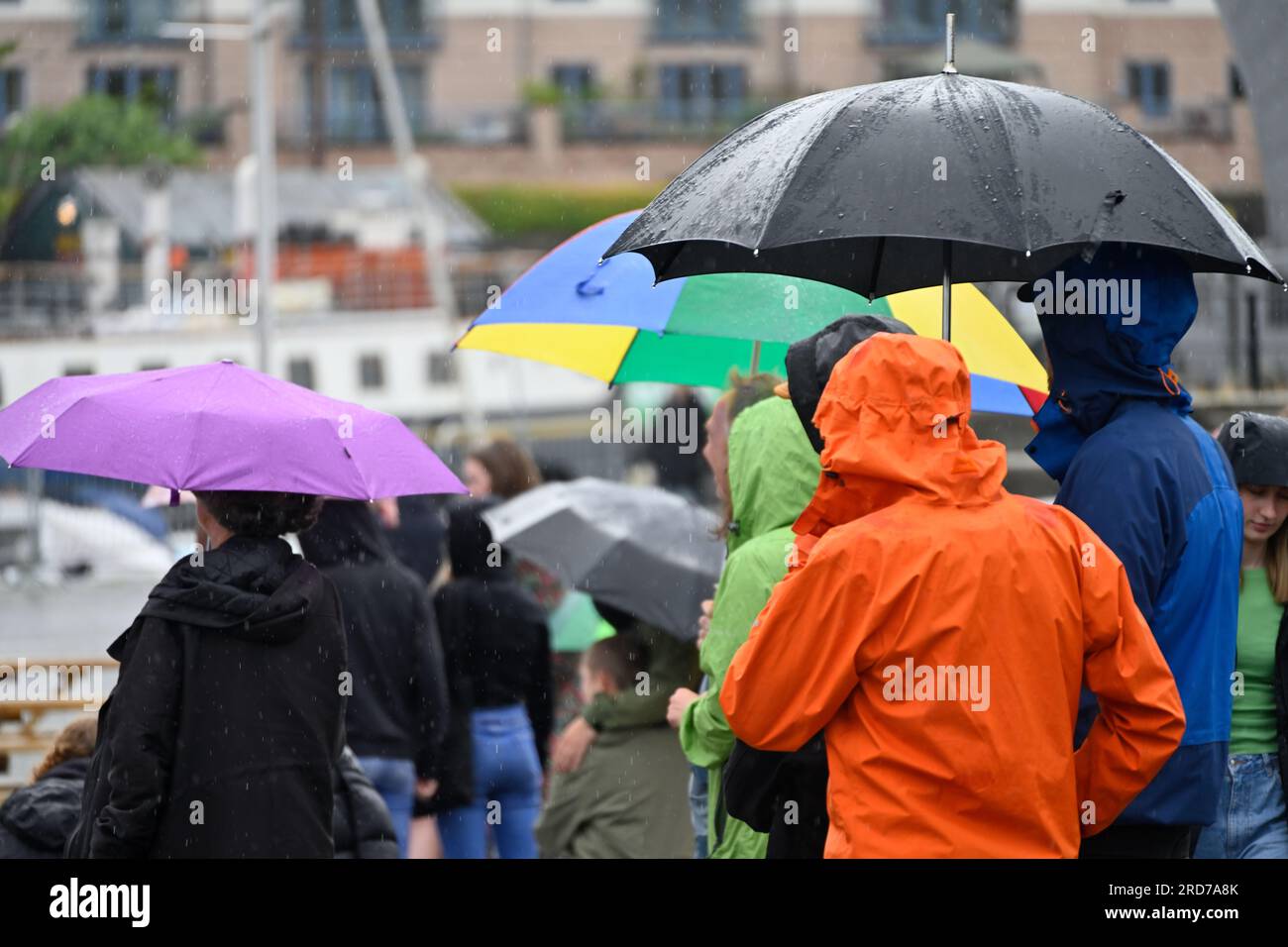 Umbrellas and rain coats out in stormy weather Stock Photo
