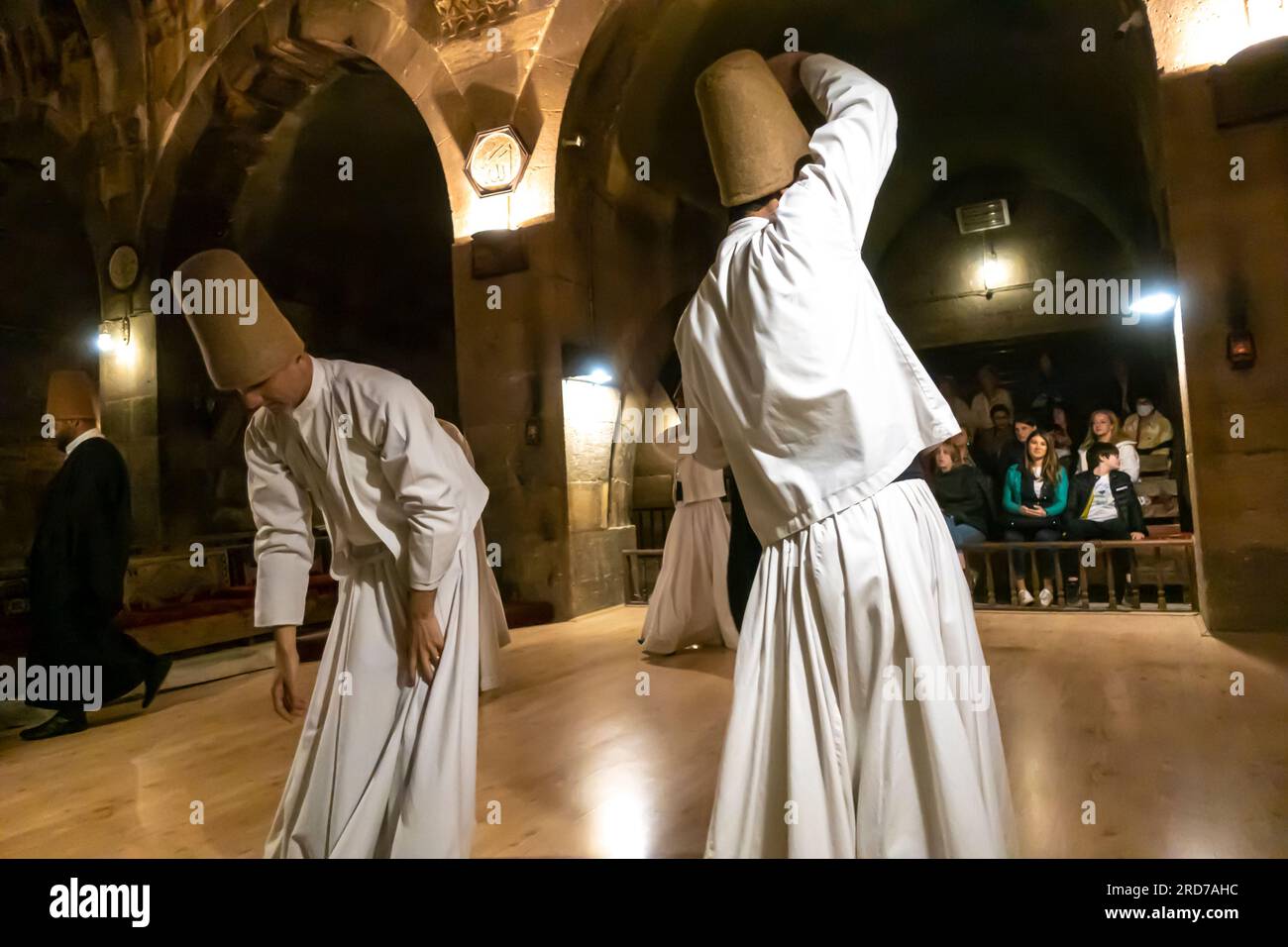 Sufi whirling dervishes from  Mevlevi order in Turkey the ceremony of Sama dance. Saruhan Caravanserai Cappadocia Turkey Stock Photo