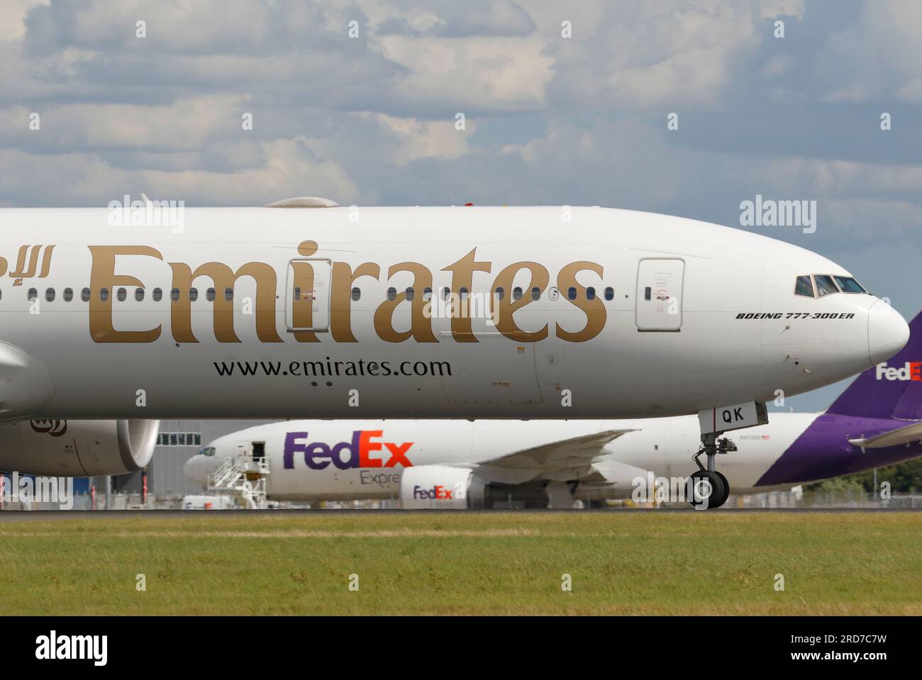 A6-EQK Emirates Boeing 777-31H(ER) with N852FD FedEx Express Boeing 777-FS2 behind. Stock Photo