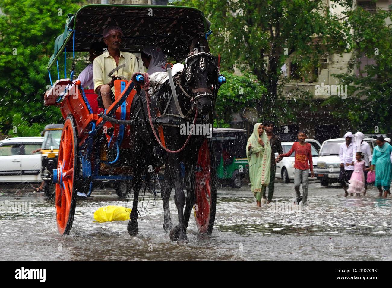 Ajmer, India. 18th July, 2023. Indian man rides his 'tanga' (horse cart) along a flooded road after heavy Monsoon rain showers in Ajmer, in the Indian state of Rajasthan, on July 18, 2023. Photo by ABACAPRESS.COM Credit: Abaca Press/Alamy Live News Stock Photo