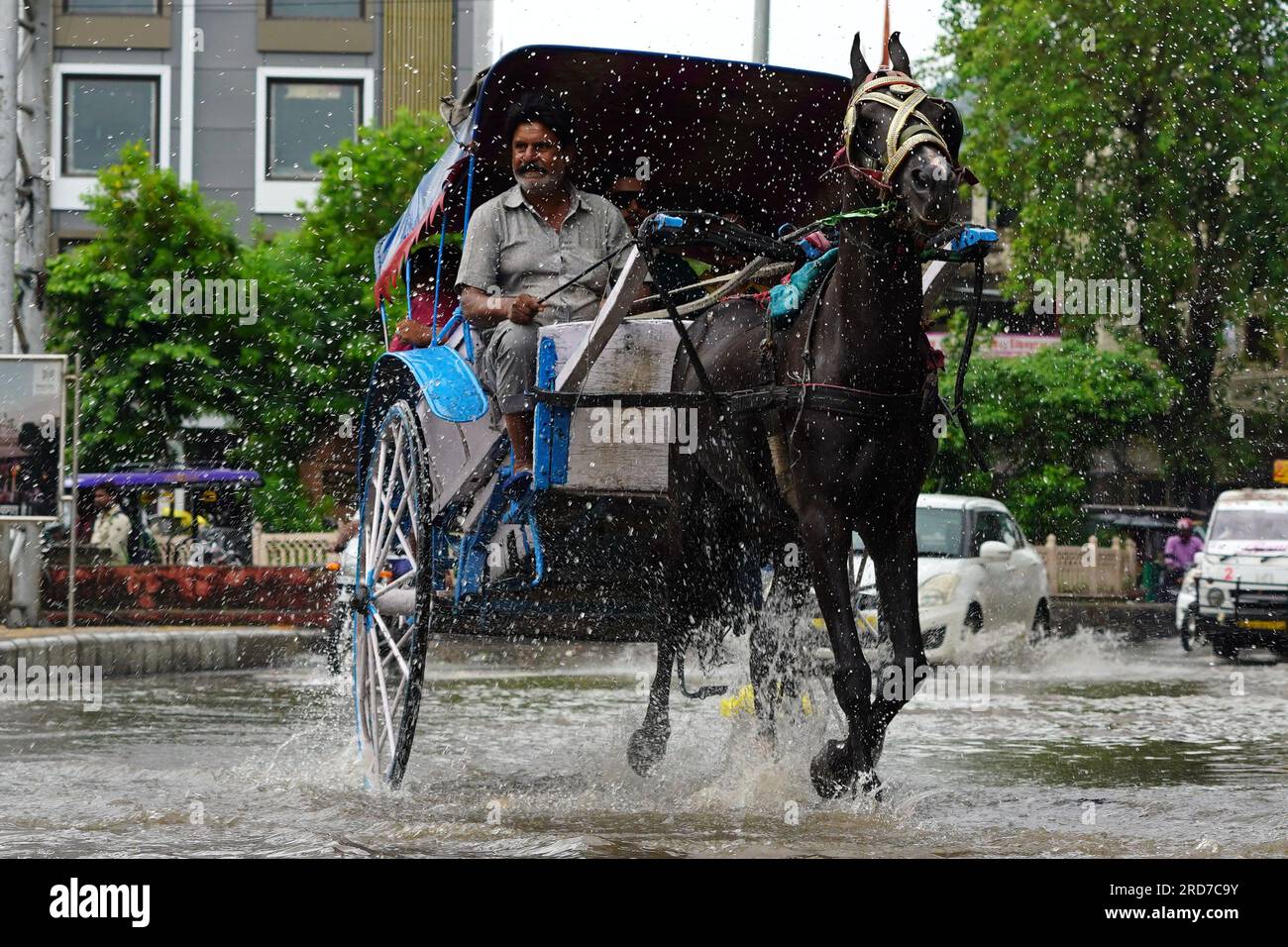 Ajmer, India. 18th July, 2023. Indian man rides his 'tanga' (horse cart) along a flooded road after heavy Monsoon rain showers in Ajmer, in the Indian state of Rajasthan, on July 18, 2023. Photo by ABACAPRESS.COM Credit: Abaca Press/Alamy Live News Stock Photo