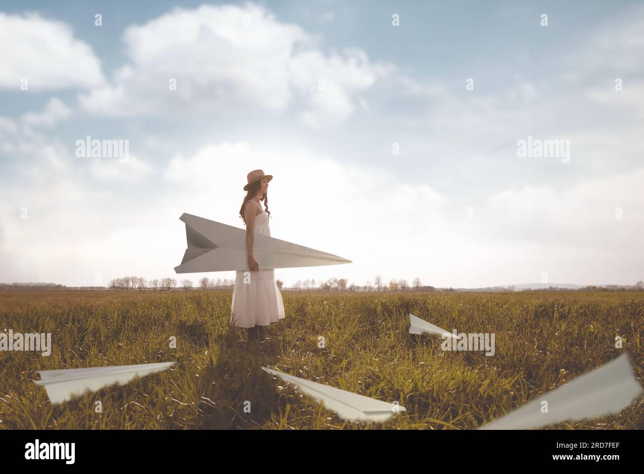 surreal woman surrounded by giant paper airplanes; abstract concept Stock Photo