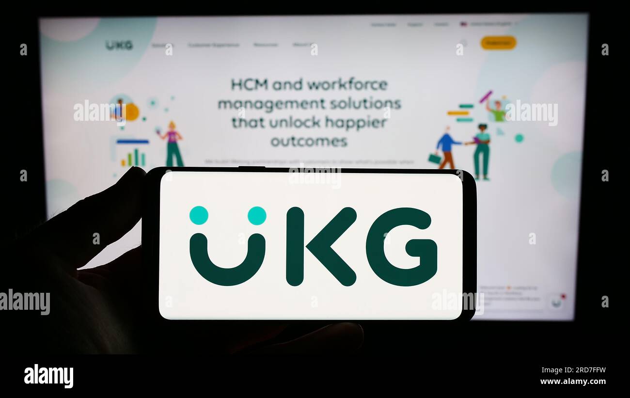 Person holding smartphone with logo of US software company Ultimate