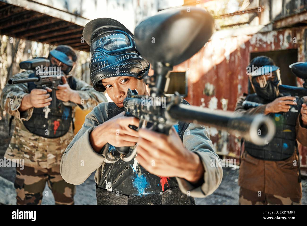 Paintball team, gun and woman focus on player challenge, target aim or  military conflict, fight or soldier mission. Group, serious or people  pointing Stock Photo - Alamy