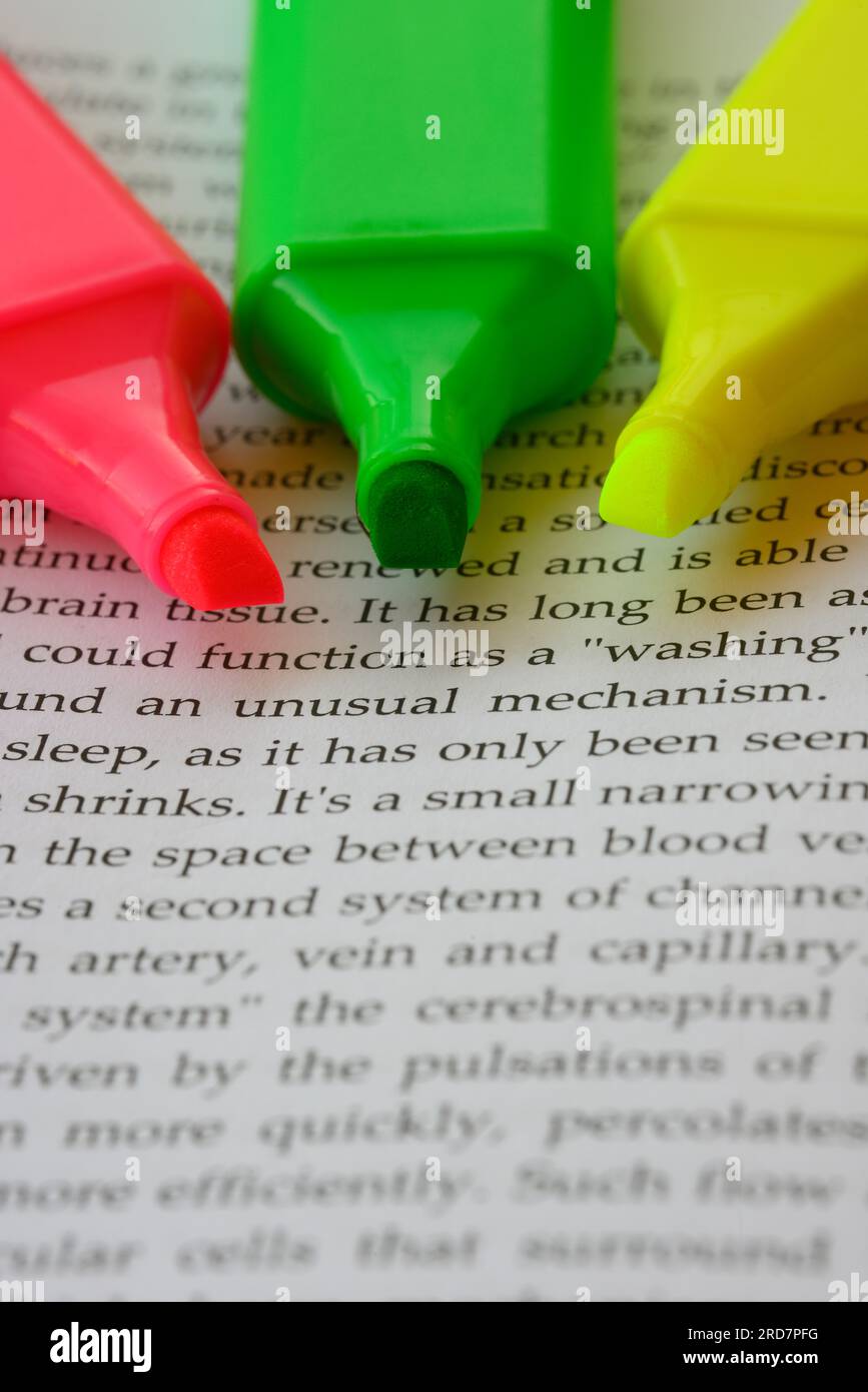 Pink, yellow and green highlighters for efficient highlighting technique to study Stock Photo