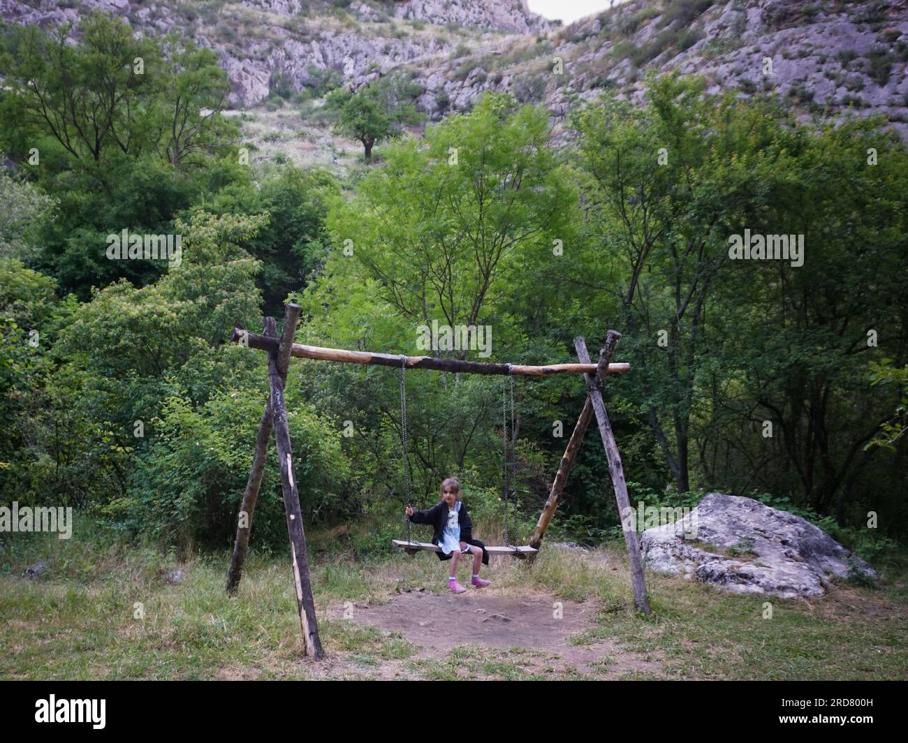 A toddler seen playing on a swing at the Honut Canyon Natural Reserve of Shusha, Nagorno-Karabakh. The unrecognised yet de facto independent country in South Caucasus, Nagorno-Karabakh (also known as Artsakh) has been in the longest-running territorial dispute between Azerbaijan and Armenia in post-Soviet Eurasia since the collapse of Soviet Union. It is mainly populated by ethnic Armenians. Stock Photo