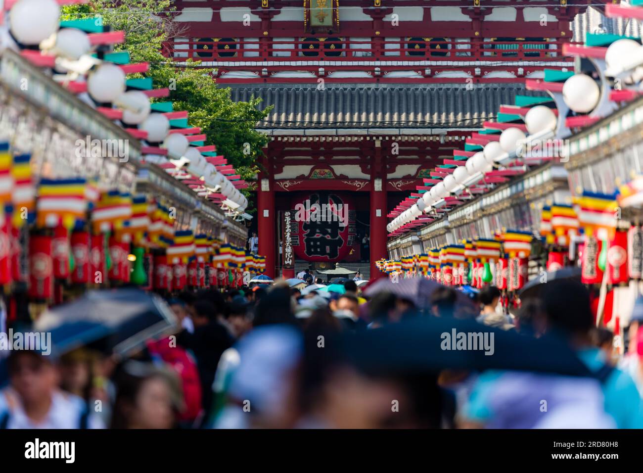 Tourists and locals crowd into Nakamise Dori Street and the Sensoji temple in Tokyo, Japan Stock Photo