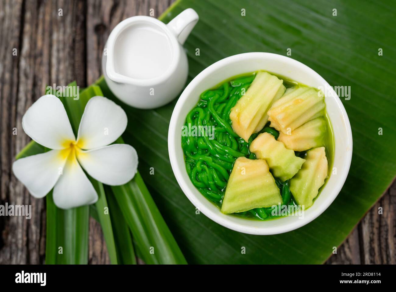Top view of Lod Chong Thai dessert with coconut milk and pandan leaf on the wood background. Stock Photo