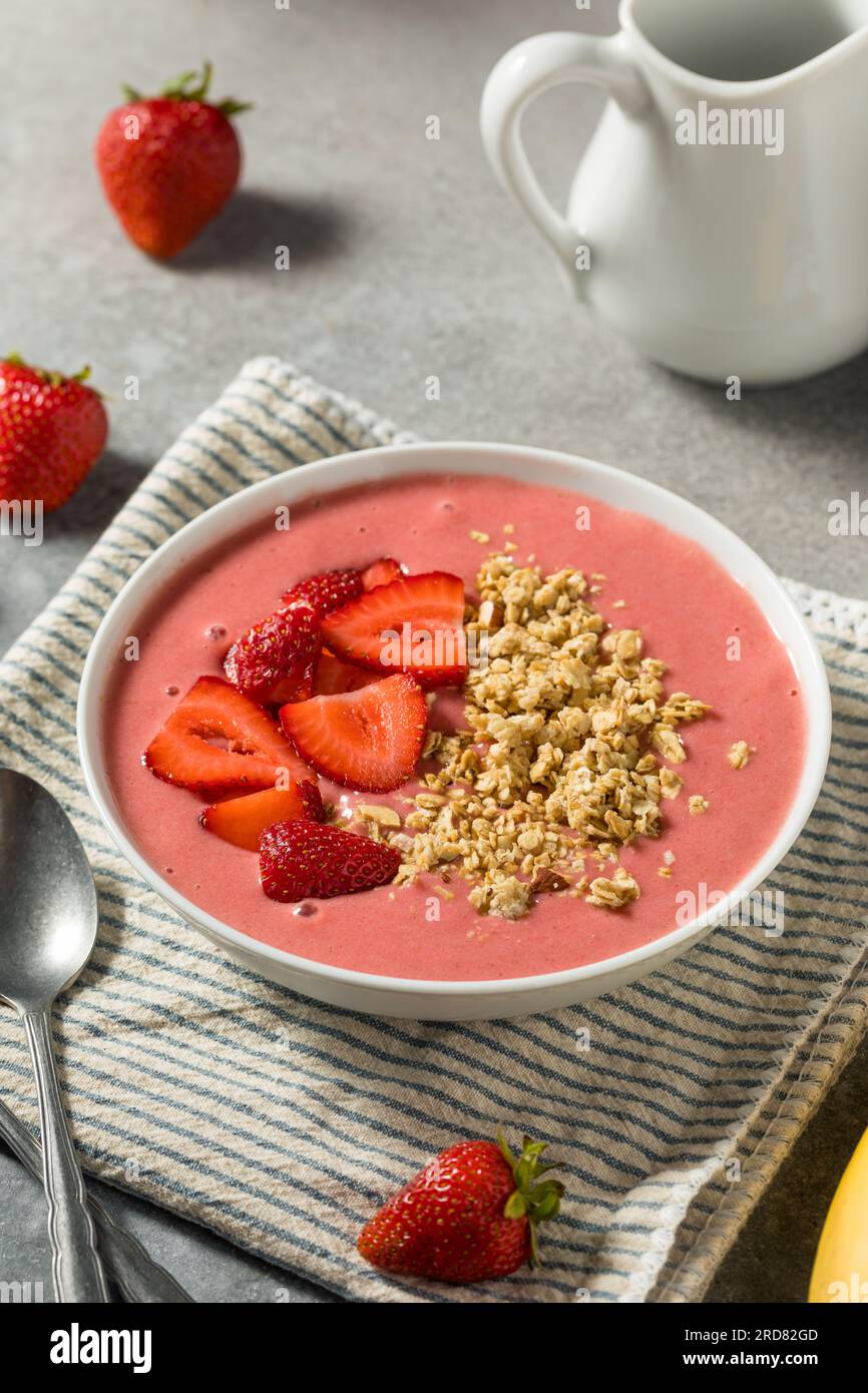 Homemade Strawberry Smoothie Bowl with Granola and Banana Stock Photo
